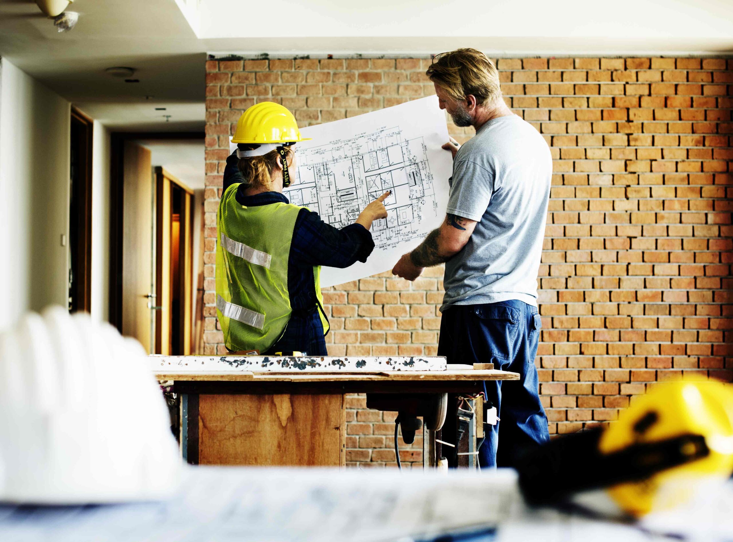 construction-team-working-on-a-blueprint-PTWBMYW_opt